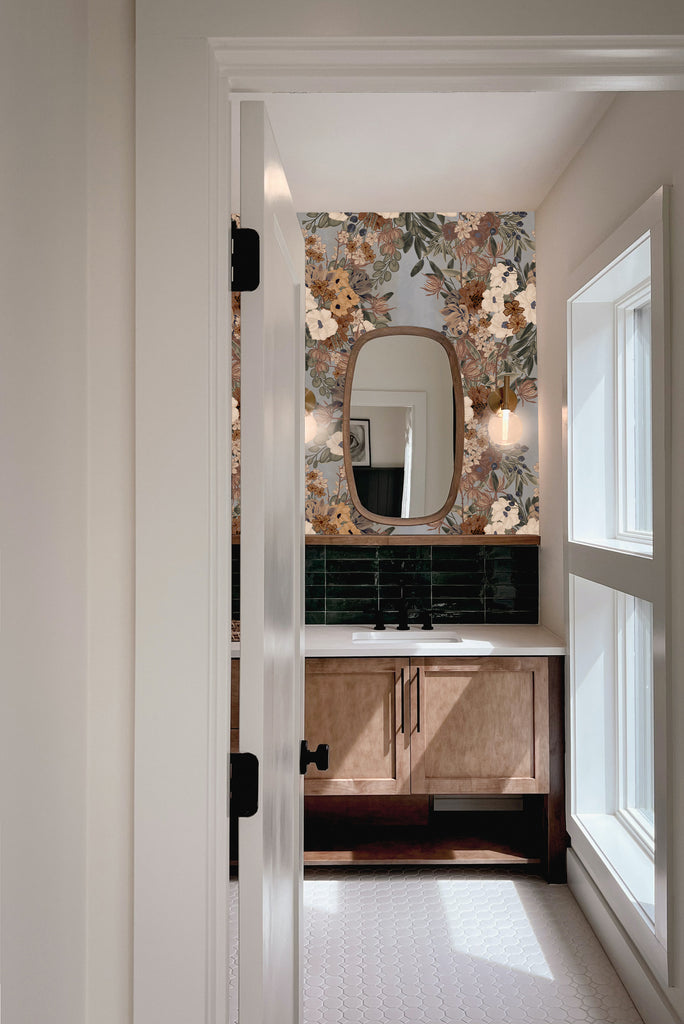 Peaking into a beautifully decorated washroom with classic removable wallpaper behind the vanity