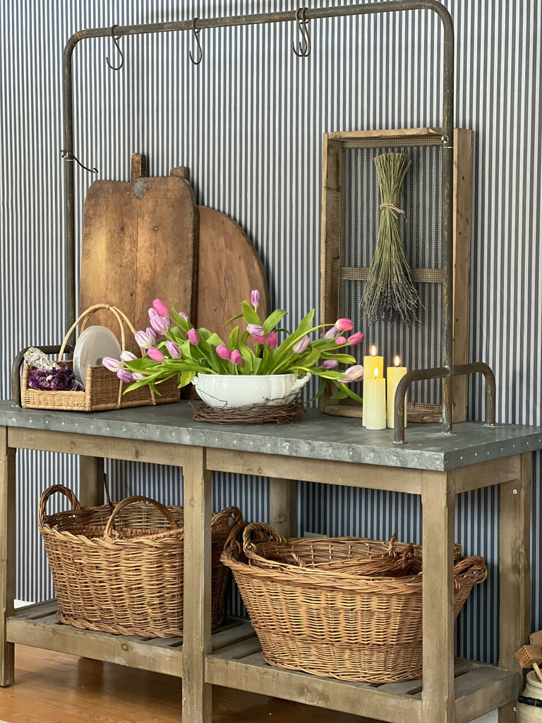 Designer whimsical kitchen makeover using removable self adhesive wallpaper featuring a blue striped design behind a vintage kitchen cart.