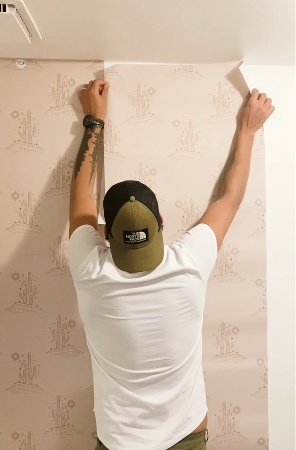 Installing western style peel and stick wallpaper in a bathroom