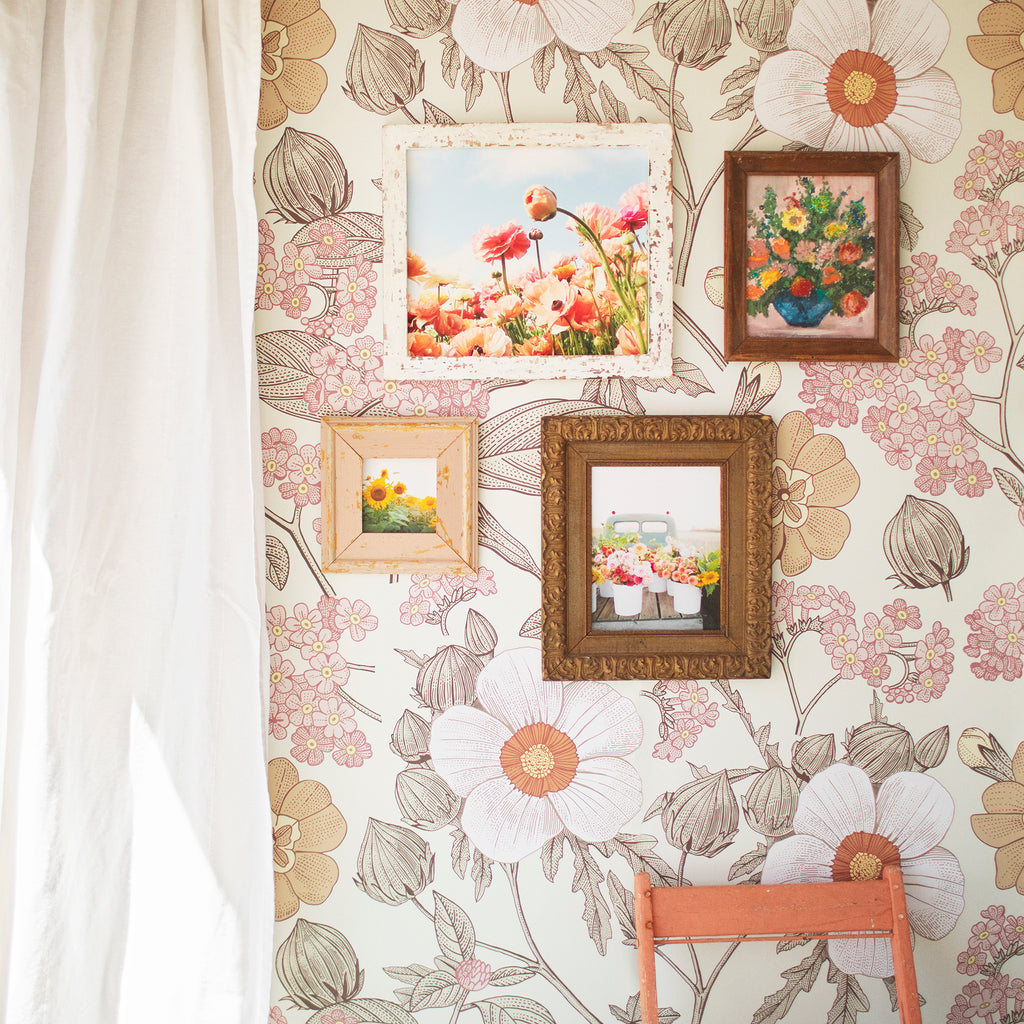 Vintage decor featuring floral peel and stick wallpaper and picture frames