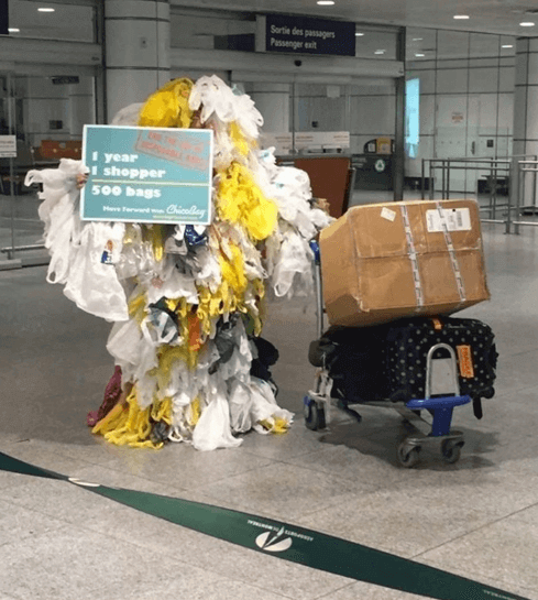 <pic of Rachel dressed as a Bag Monster at Montreal airport to raise awareness on the issue and promote the upcoming documentary screening.>