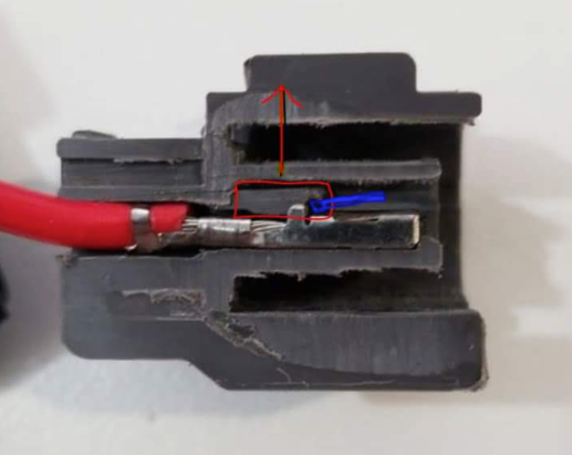 Cross section of connector. Insert small screwdriver where marked in blue. Lift the tab circled in red. The wire should then easily pull out the back of the connector.