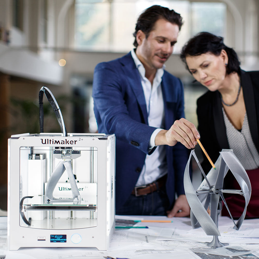 wo designers discussing a model printed on Ultimaker 2+ with its open filament system