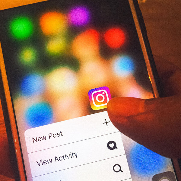 Sprinkle Club - Someone using instagram on their phone to view their business account insights
