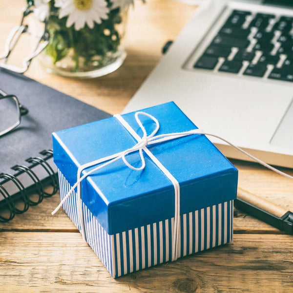 Sprinkle Club - A striped gift box with a bow on a table top for Father's Day