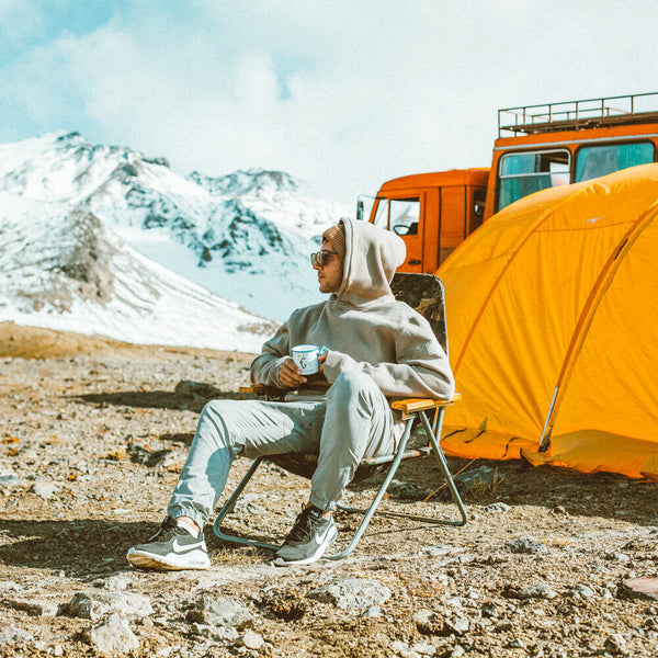 Sprinkle Club - A Dad sitting in a camping chair on the top of a mountain with a coffee