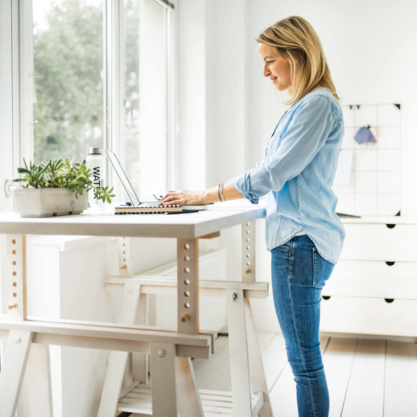 Sprinkle Club - A woman using a standing desk in her home office space