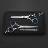 hair cutting scissor and thinner lying on leather pouch