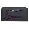 Purple scissors, black razor, comb, and pouch on white background close-up