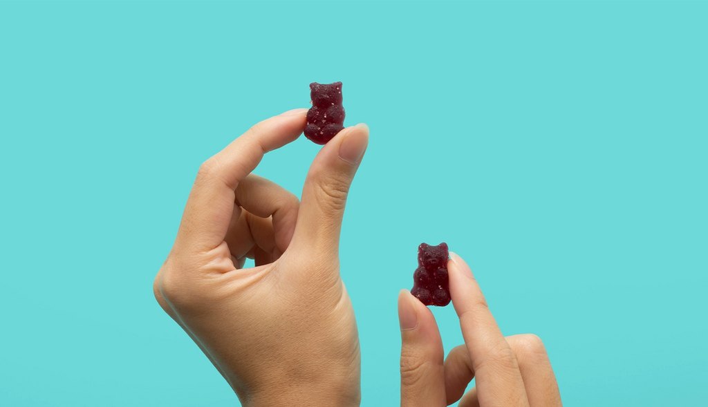 Hand Displaying CBD and CBN Gummies for Sleep