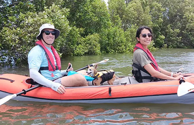 A couple and their dog enjoying a paddle in the Advanced Elements Convertible Elite Inflatable Tandem Kayak