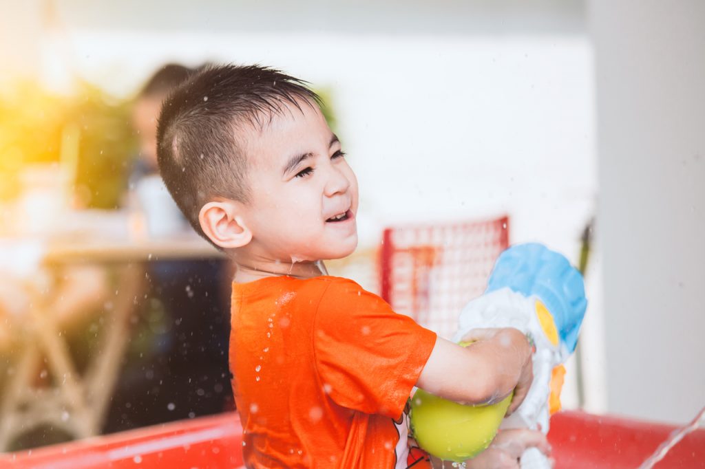 A little boy playing backyard water games