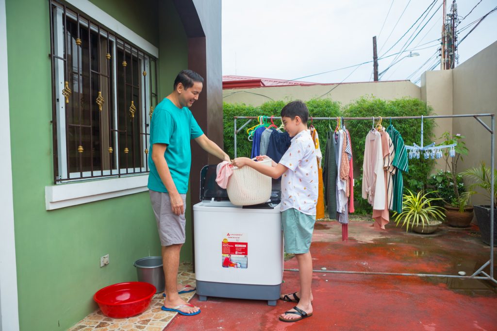 Father and son doing the laundry