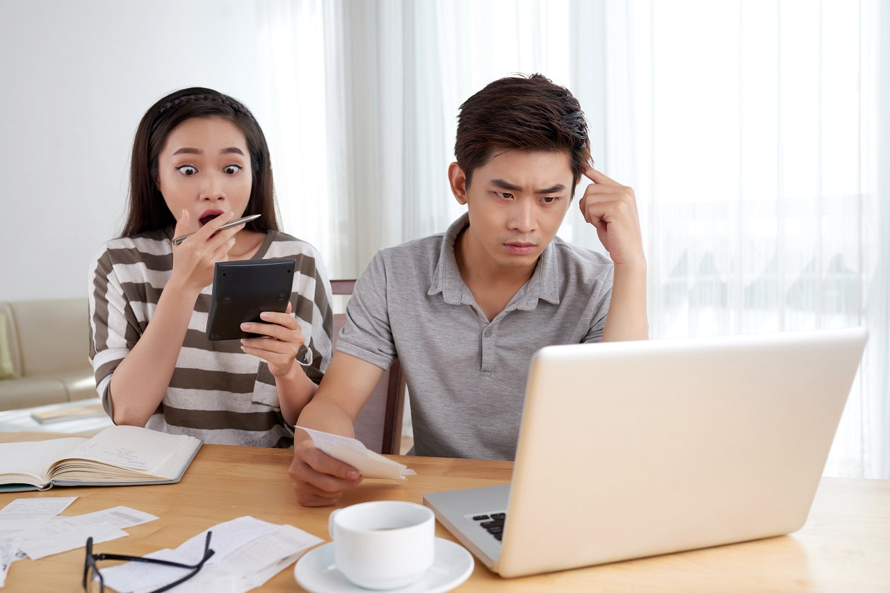 A young couple surprised at their electricity bills