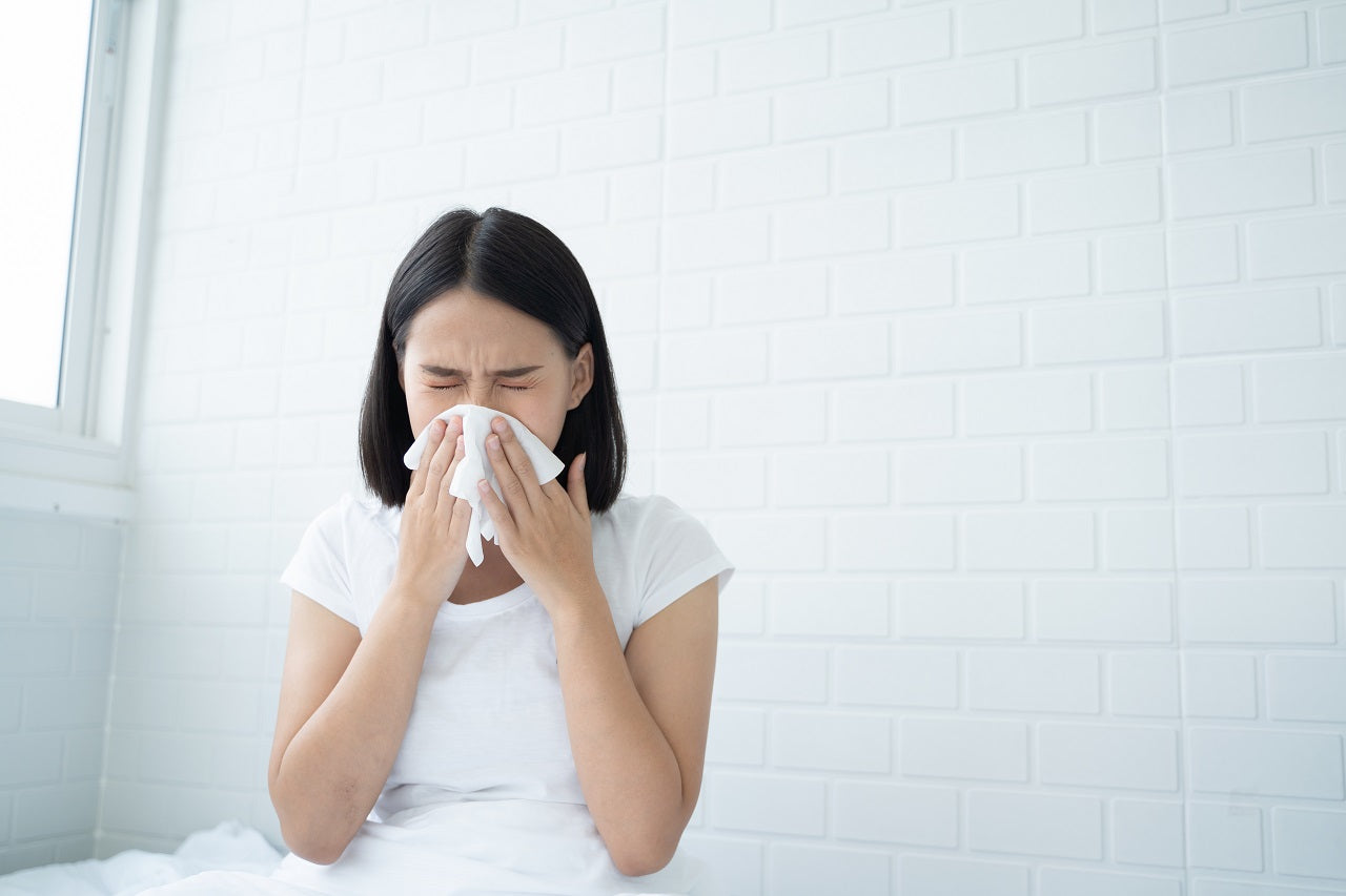 A young Asian woman sick with a cold