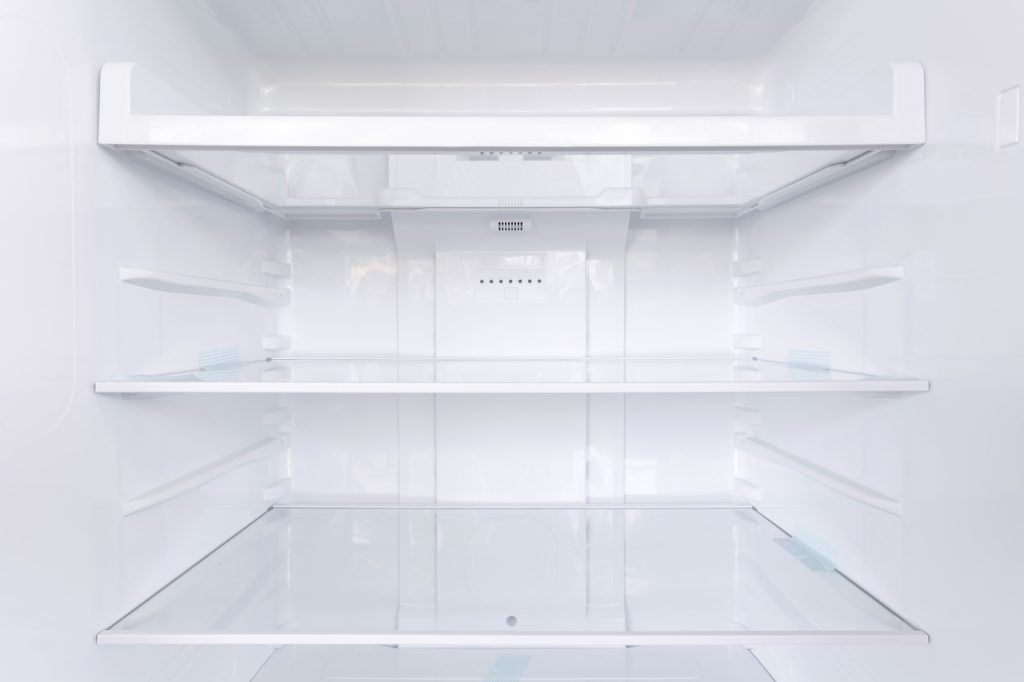 Large empty shelves in the refrigerator.