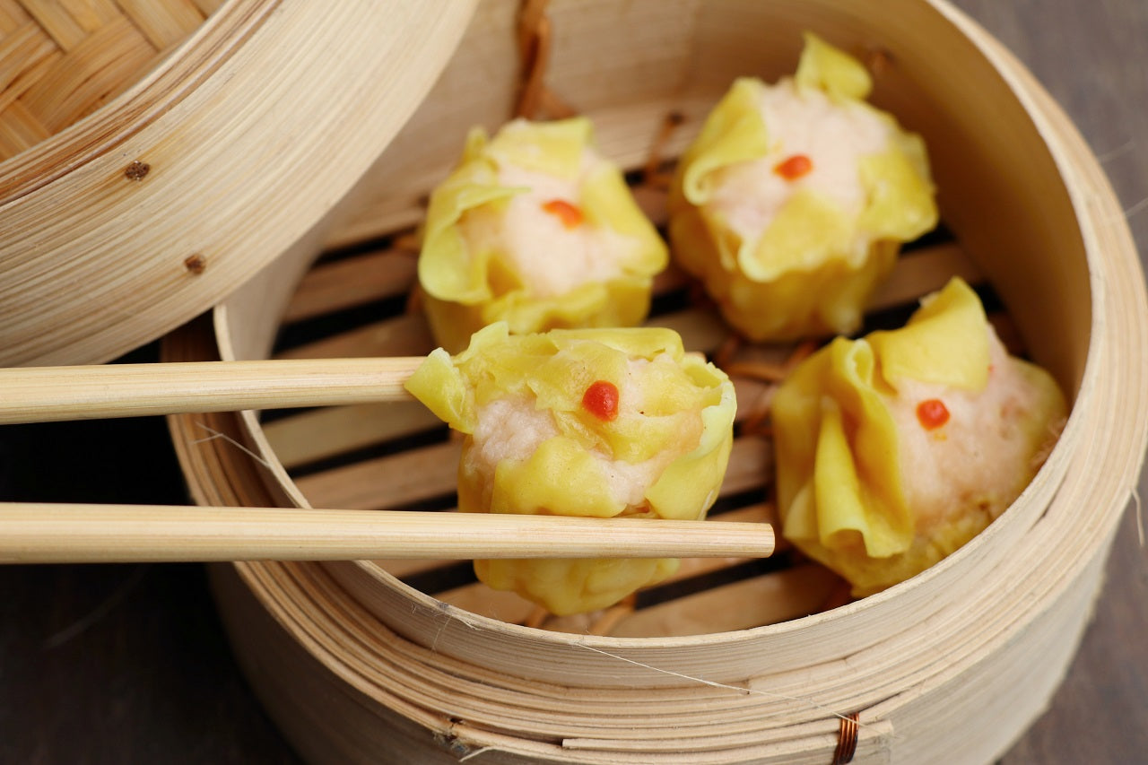 4 piece of Chinese siomai dumplings on a steamer