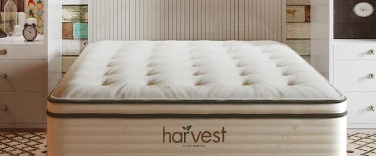 Harvest pillow top mattress with a big Harvest logo on the front - white mattress with green trim