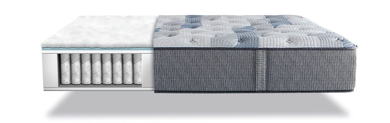 Gray hybrid mattress with the side cutout so you can see the springs topped with layers of memory foam