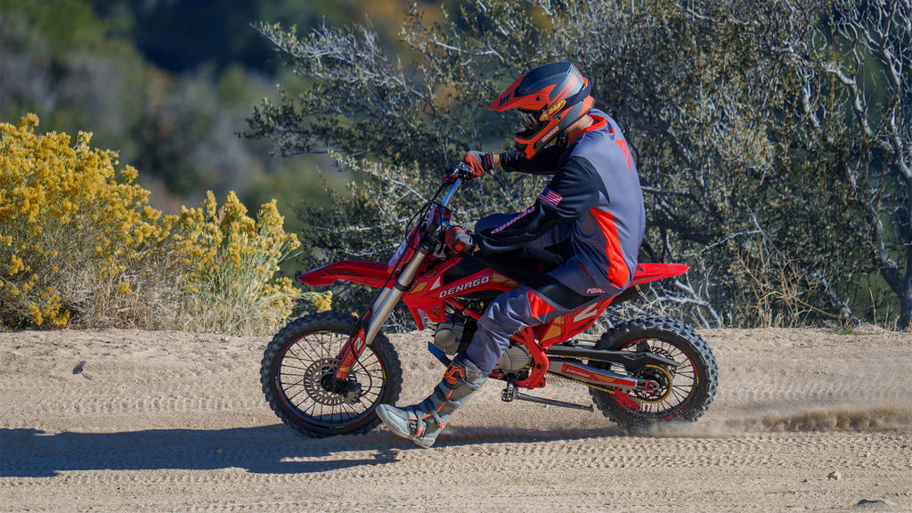 Person riding on an off road track on a Denago Powersports MX2 Dirt Bike