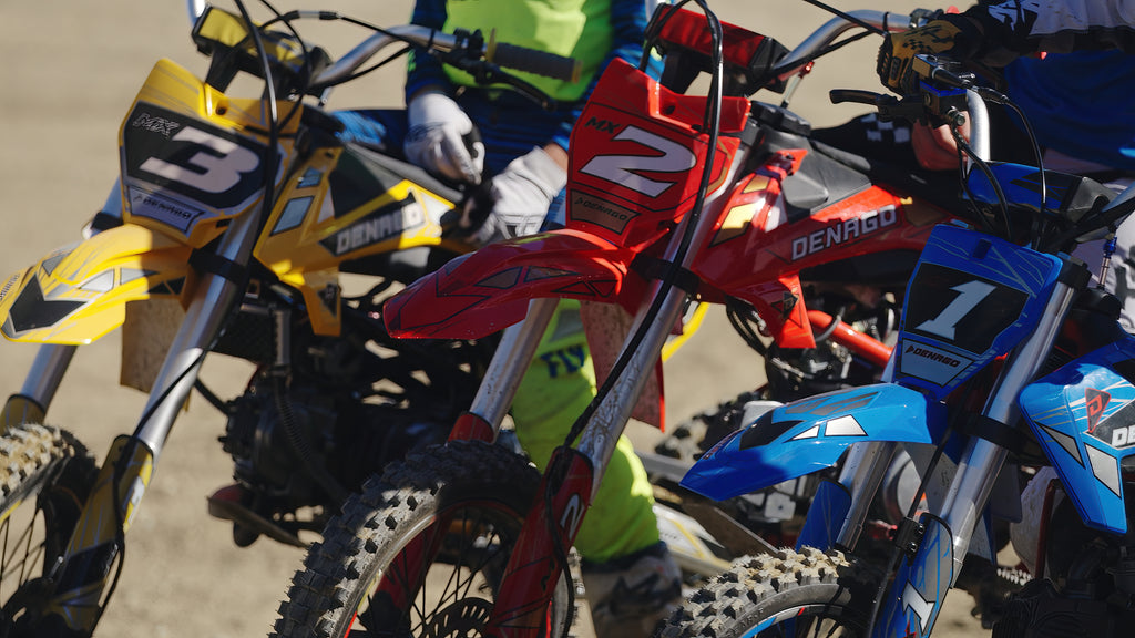 A close up of the Dengao Powersports MX3, MX2, and MX1 Dirt Bikes lined up next to one another
