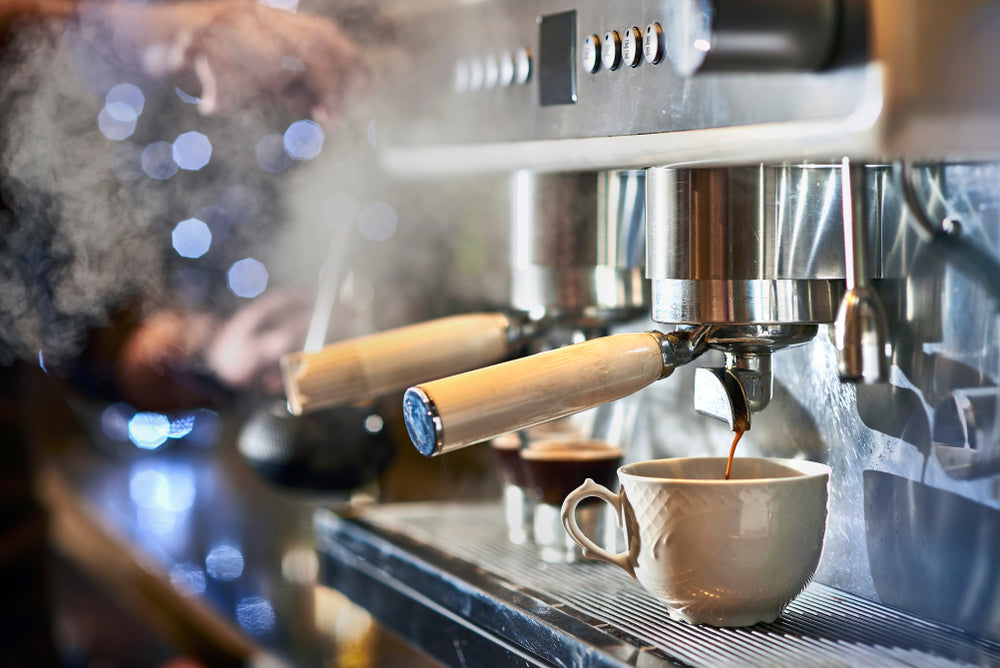 Barista making a espresso with a classic Italian coffee machine