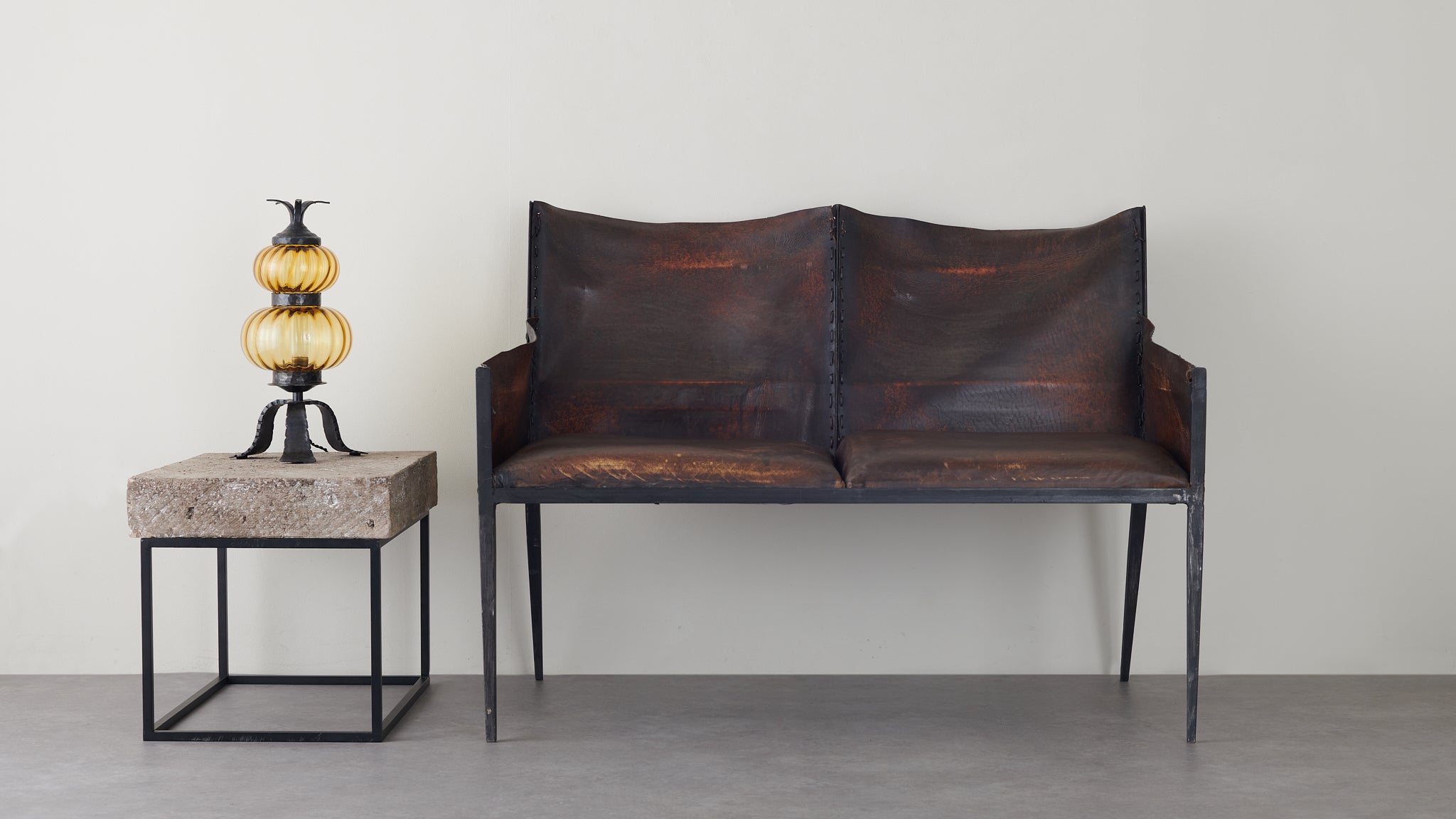 IRON AND LEATHER TWO SEAT SETTEE IN THE MANNER OF JEAN-MICHEL FRANK