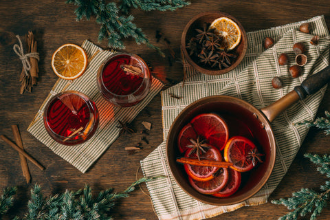 non-alcoholic mulled wine in glasses and in a saucepan being warmed