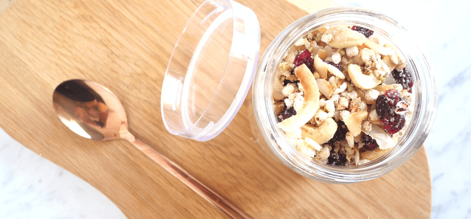 seed cycle granola recipe on timber chopping board, rose gold spoon and marble table