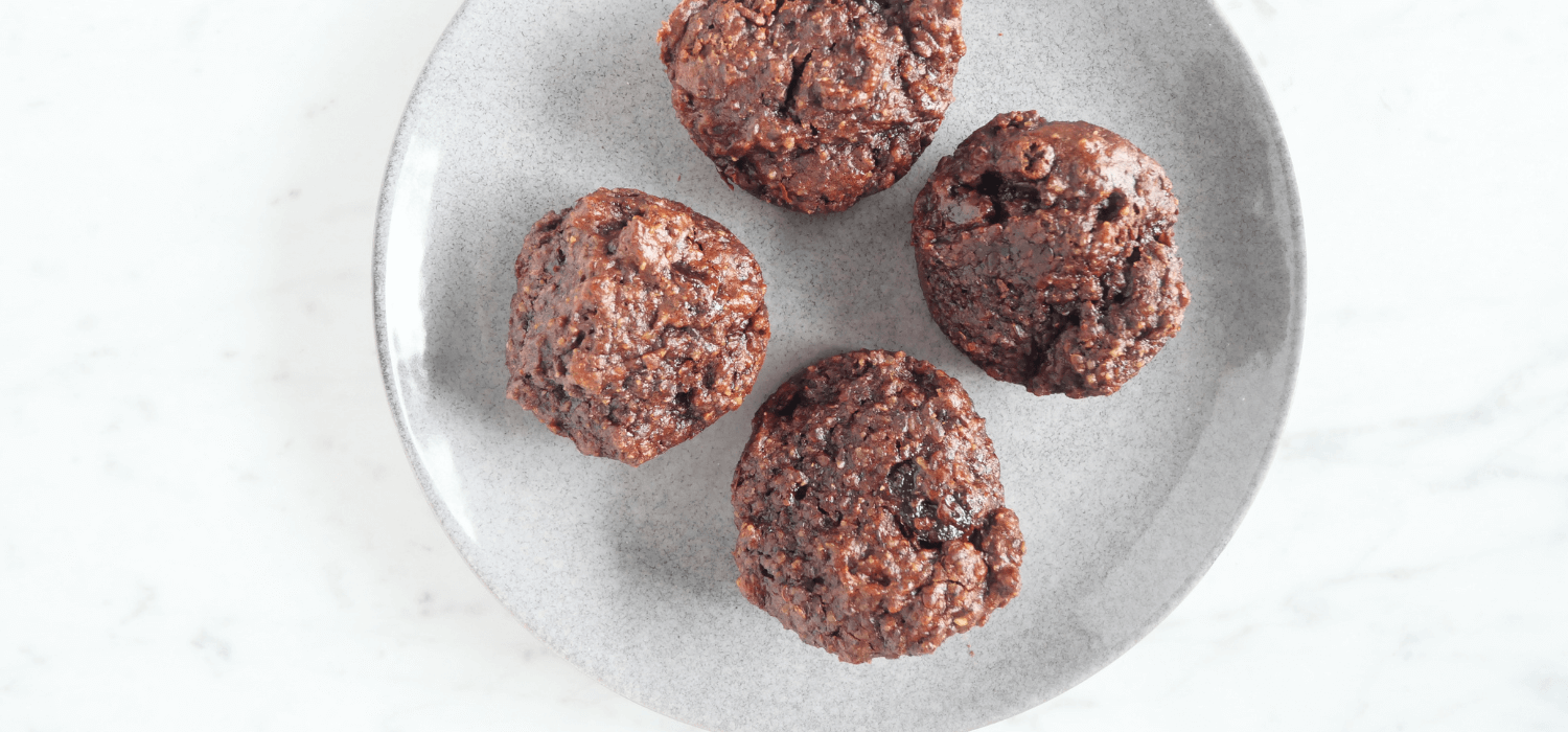 Cacao Date Muffins for Seed Cycling on marble background and white plate