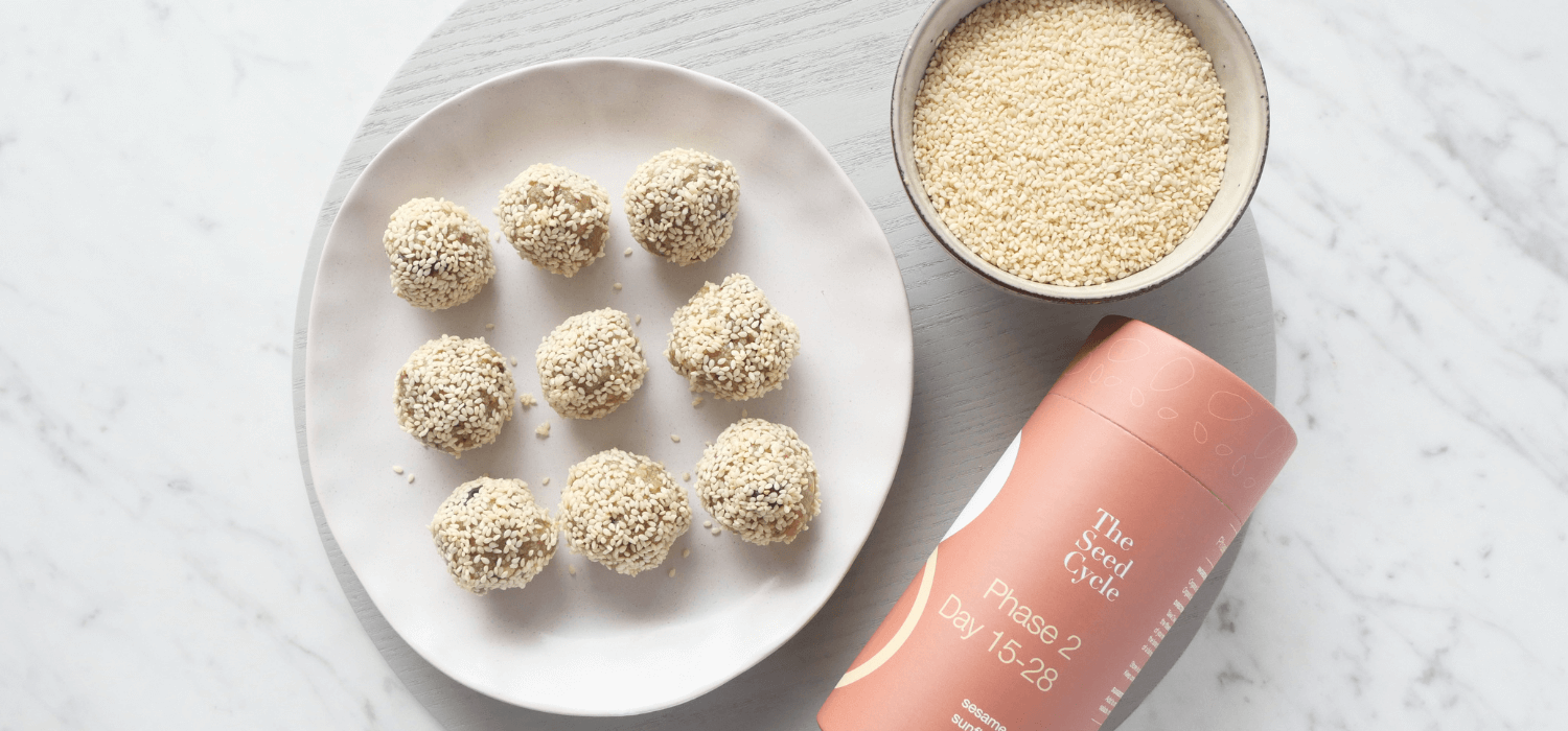 vanilla seed cycle bliss balls, seed cycling recipe, The Seed Cycle Phase 2, marble background, sesame seeds in a bowl