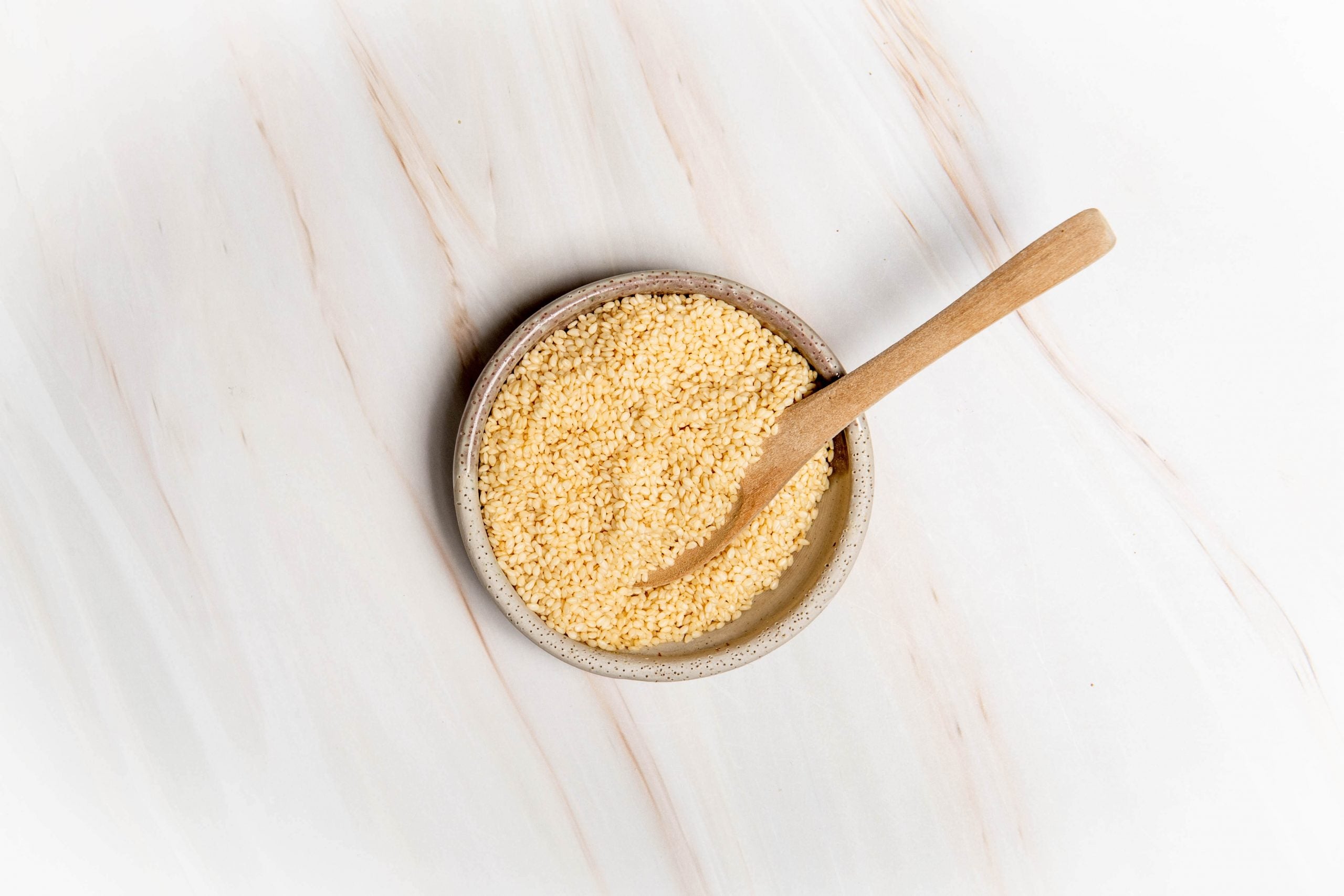 A bowl of sesame seeds sitting on a kitchen bench. How does seed cycling work?
