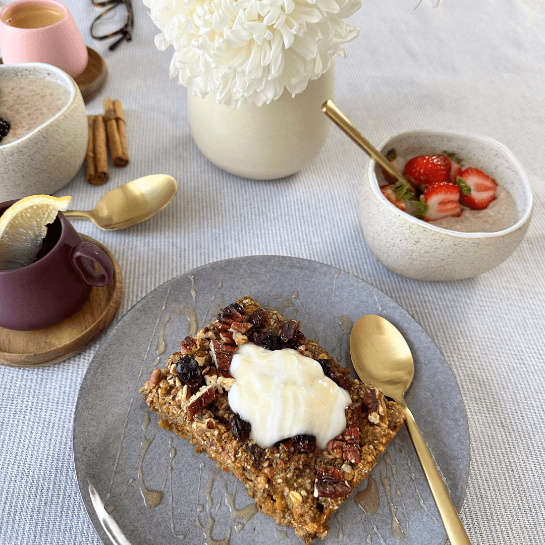Seed + Oat Carrot Breakfast Bake served on a plate topped with yoghurt