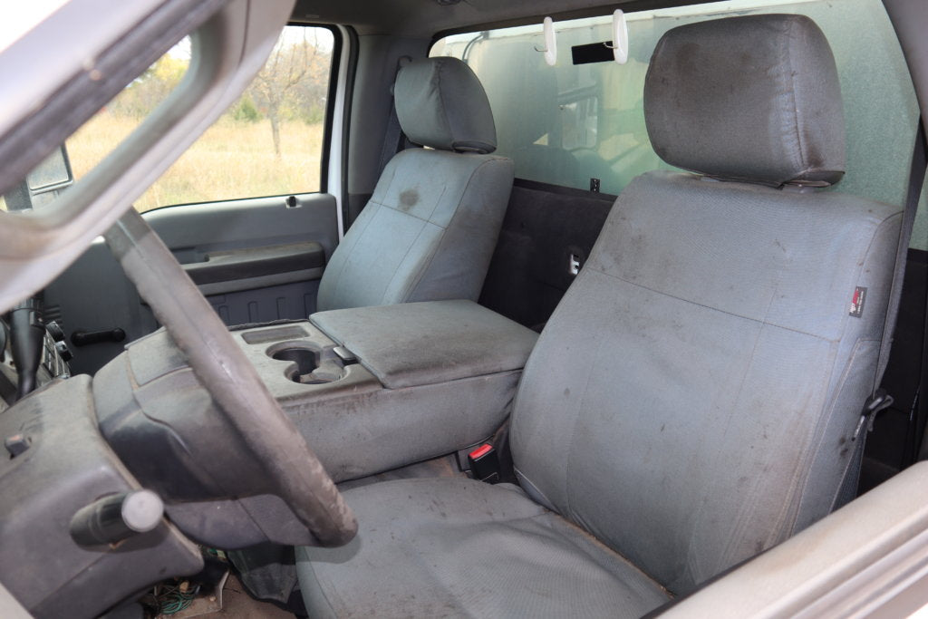 Interior shot of a service vehicle with eight years of wear on the TigerTough seat covers.