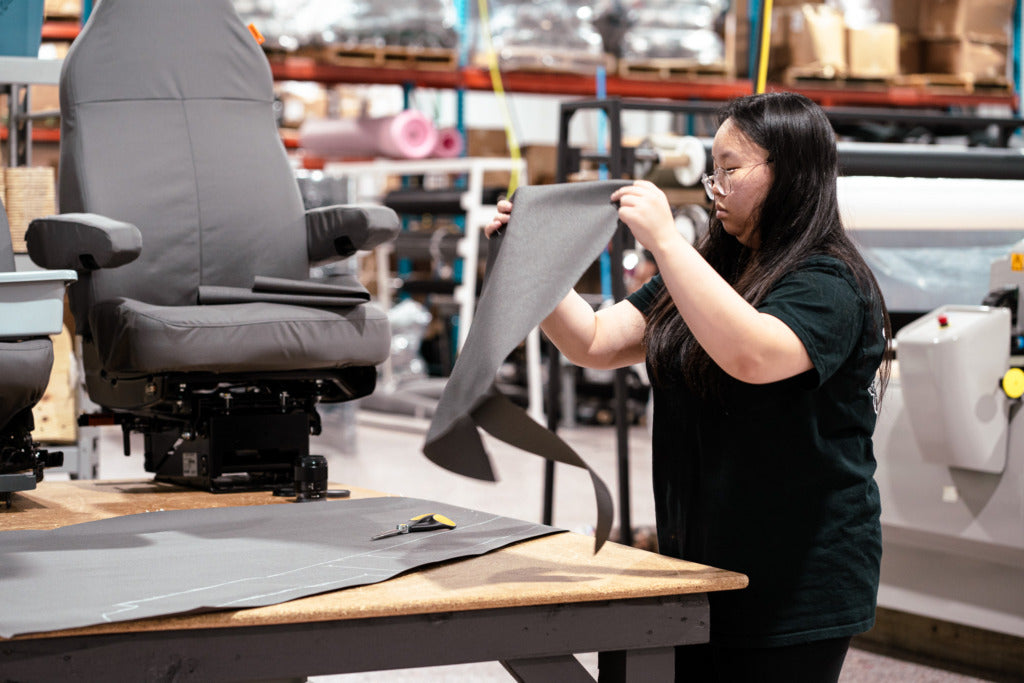 Woman creating a TigerTough seat cover prototype.