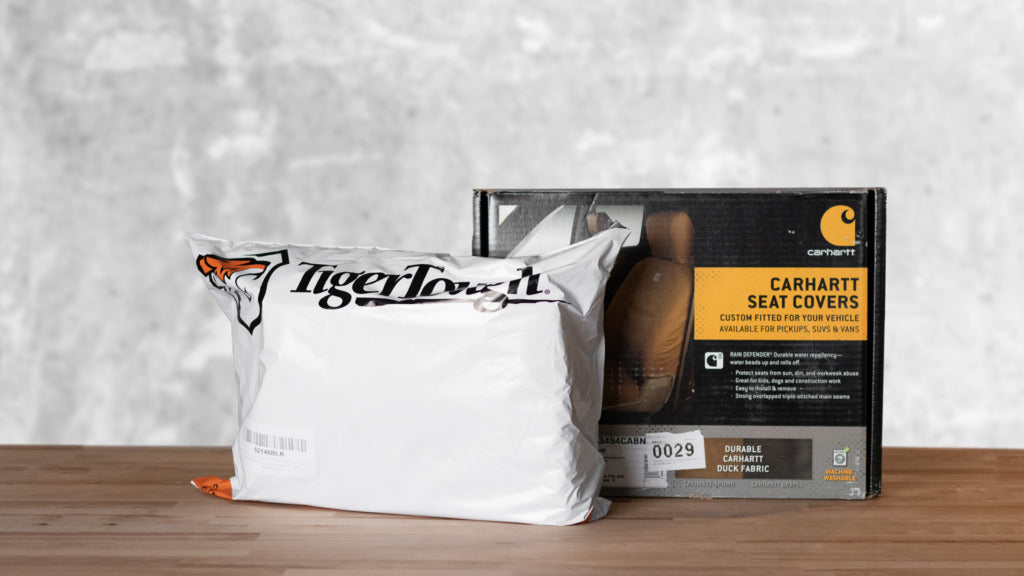 Tigertough packaging in a bag and Carhartt seat covers in a box.