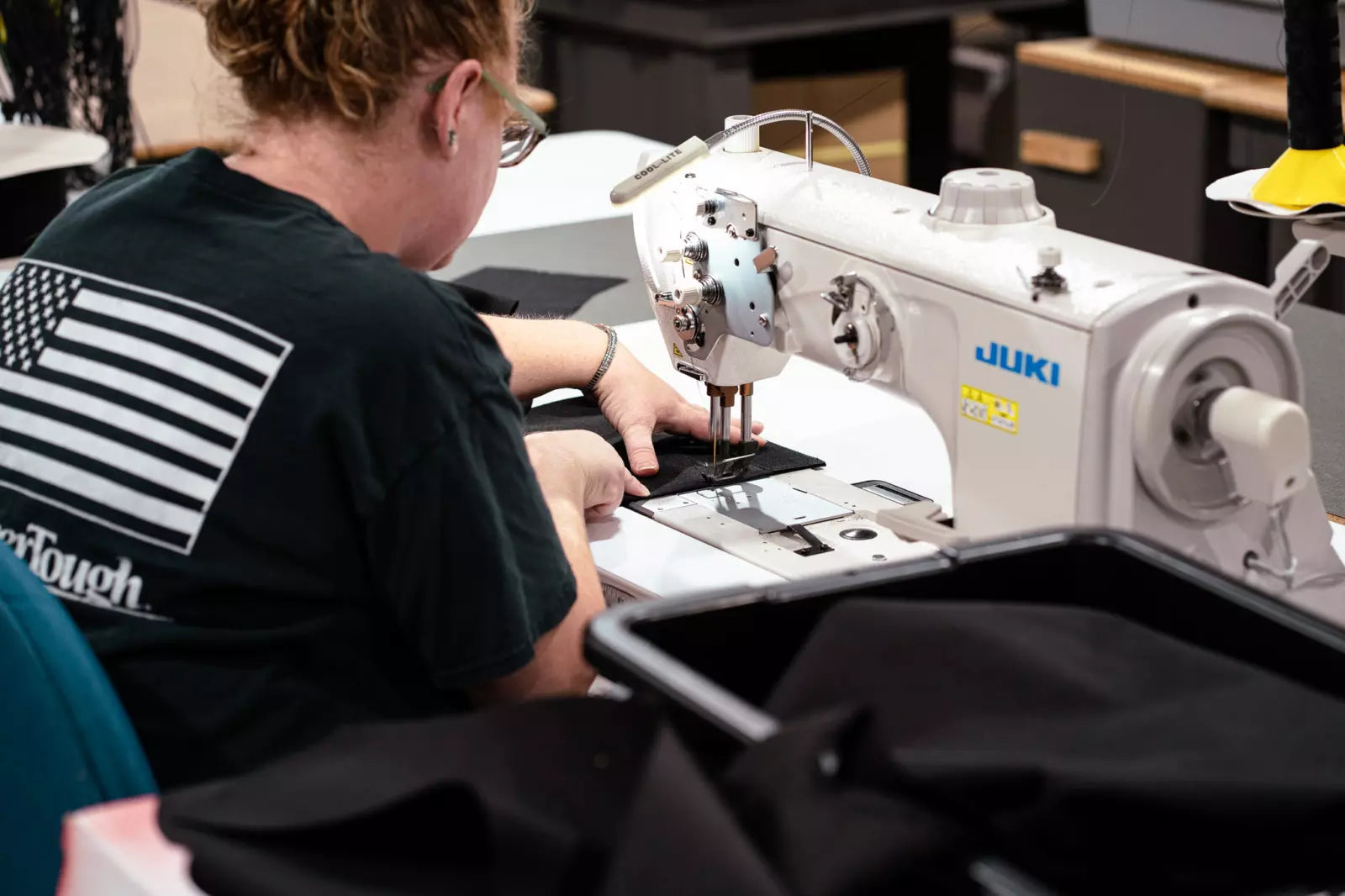 TigerTough cover being hand sewn by a woman with red hair