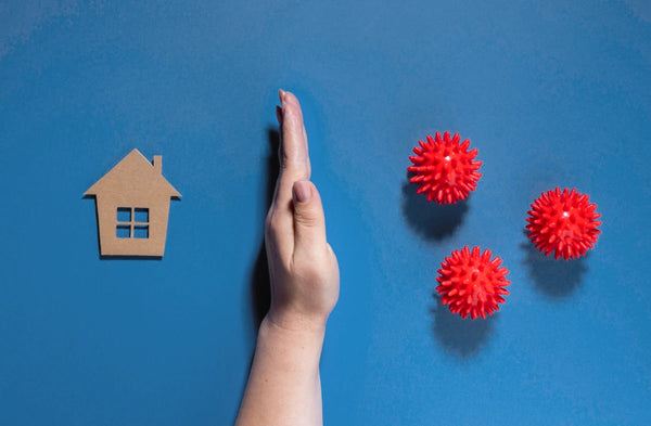flat-lay-hand-protecting-house-from-viruses