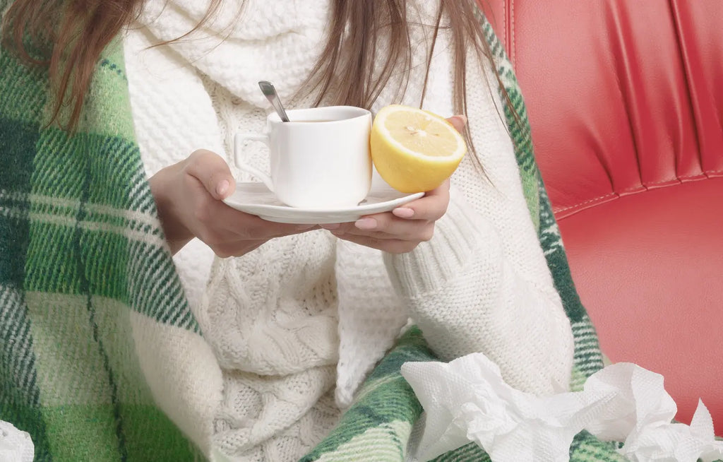 sick-young-woman-looking-her-cup-tea