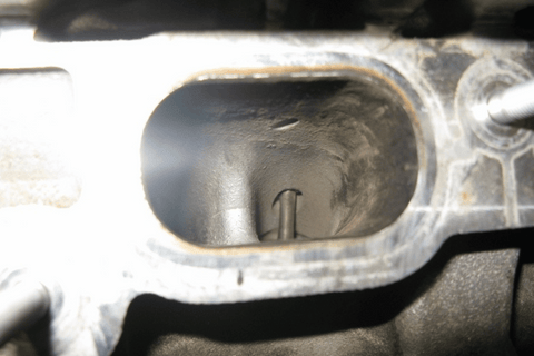 Be wary of companies that do not use the proper equipment. BMW designed a specific tool for this. If you mechanic says that he will just spray some degreaser or brake clean in the port and scrub with a brush, he will likely damage your engine.