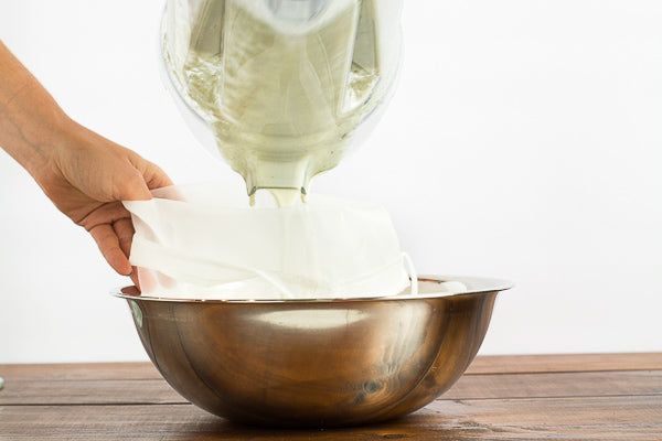 Pumpkin seed milk strained from blender to bag. Makes a creamy, nutritious milk alternative. 