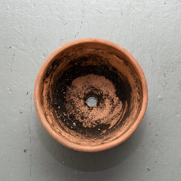 empty pot with a hole