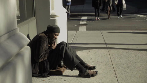 black man sitting on sidewalk on sunny day - homeless man – NY Clips