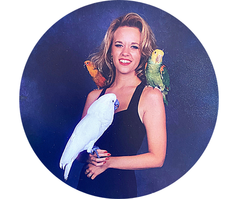 Mystery author Wendy Neugent with three parrots