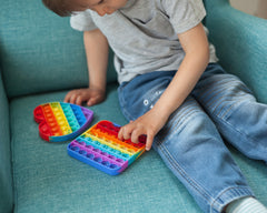 Child playing with pop it fidget toys