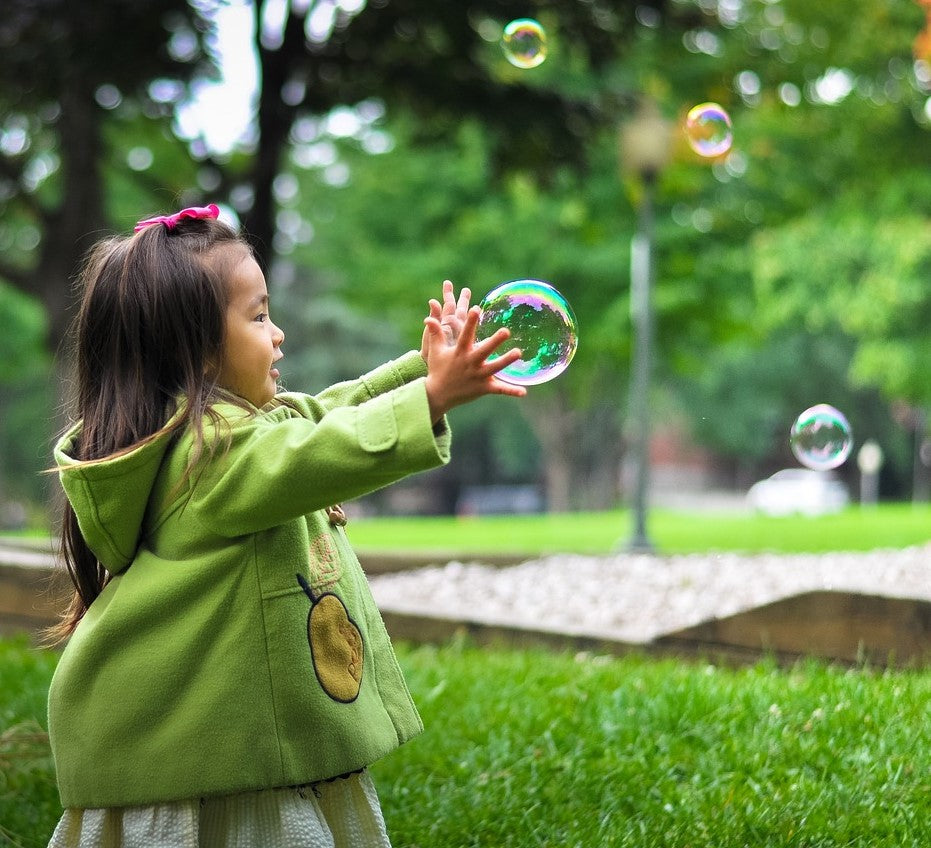 kid playing with bubbles | Yellow Scope