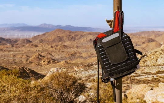 IMS Pro hydration backpack hangs from a pole out in the wilderness.