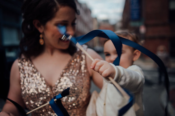 gold bridesmaids dress navy blue streamers at wedding