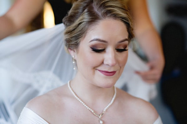 bride putting on mantilla veil