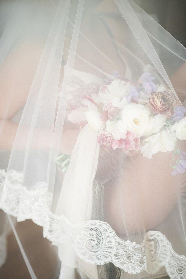 boudior bridal photo shoot with mantilla wedding veil and bouquet